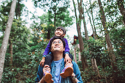 father daughter hiking in woods