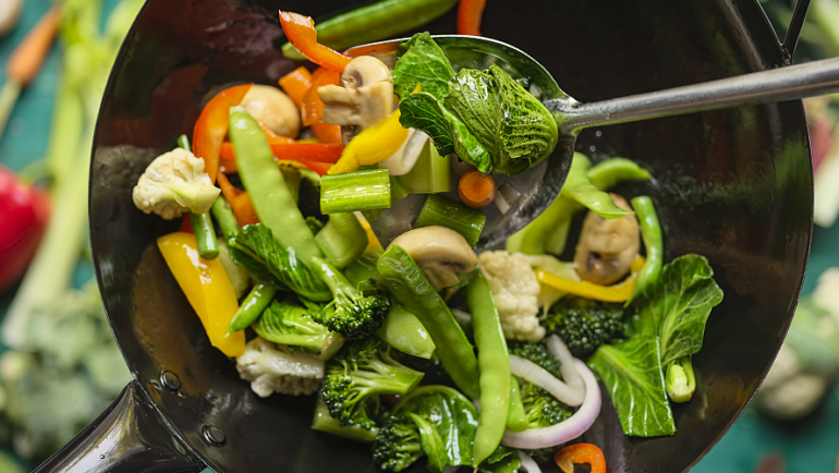 stir-fry vegetables in wok