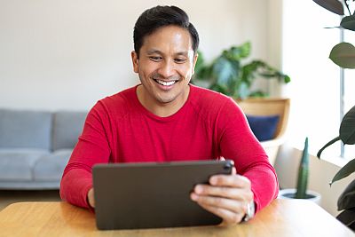 man working on laptop or tablet at home
