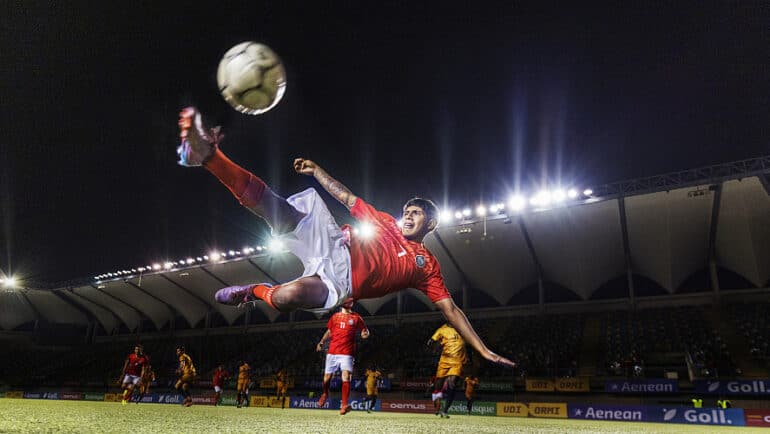 athlete soccer kicking ball