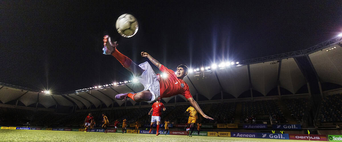 athlete soccer kicking ball